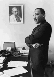 Martin Luther King, Jr. beside a picture of Gandhi; photograph © Bob Fitch